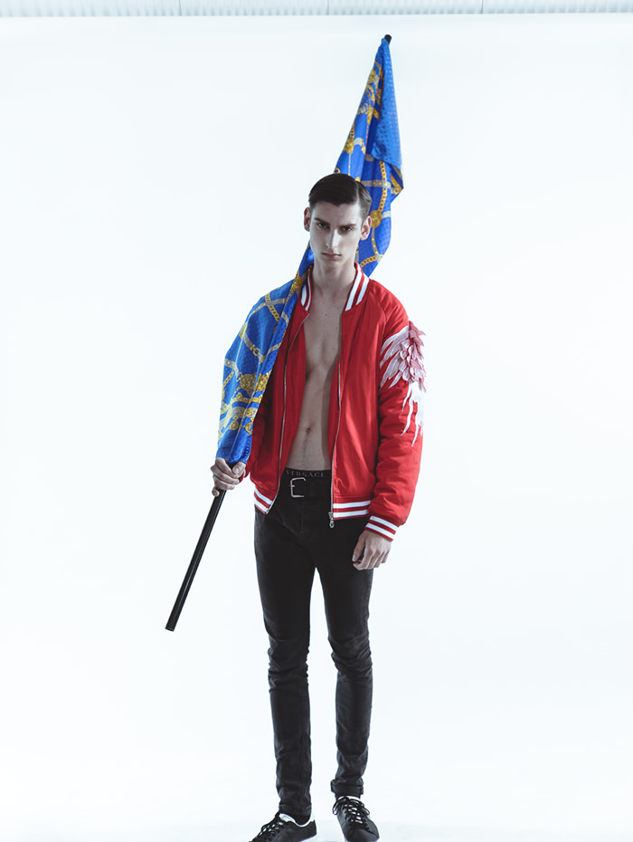 ANTHONY is wearing Jacket - United Union of Deviants, Belt - Topman, Boxers - Versace, Jeans -  Acne Studios Shoes - Fred Perry