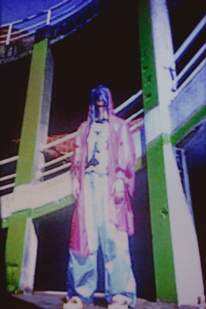 K-way by Fabien Verriest, top by Super Piece of Chic, pants by Walter Van Bierendonck, shoes are a collaboration by Jennifer Lecrique, Nicolas Watteijne, and Fabien Verriest