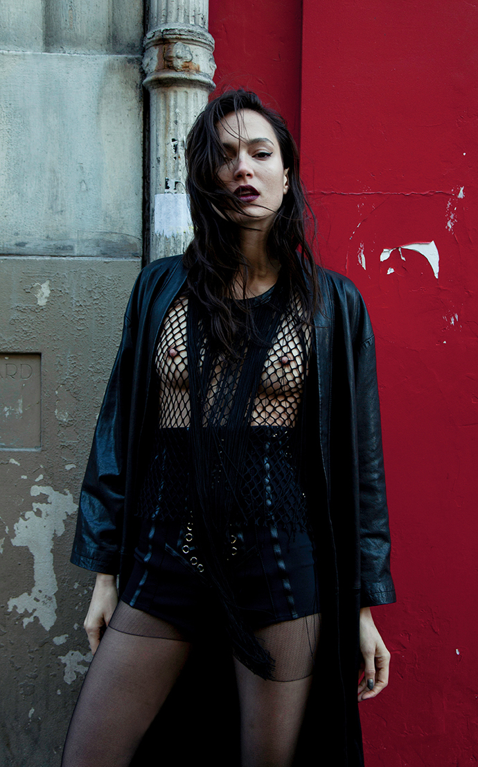 long leather coat : AINUR TURISBEK fringed mesh top : Augustin Teboul short : Elisabetta Franchi high boots : Musette Paris