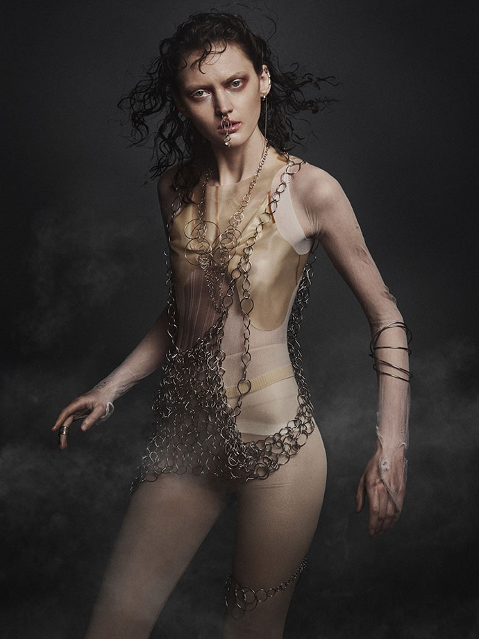Latex top by Alex Ulichny , Bodysuit torn Nylon, Chains and Face Jewelry by Edgar Mosa, Earrings by AKA Jewelry