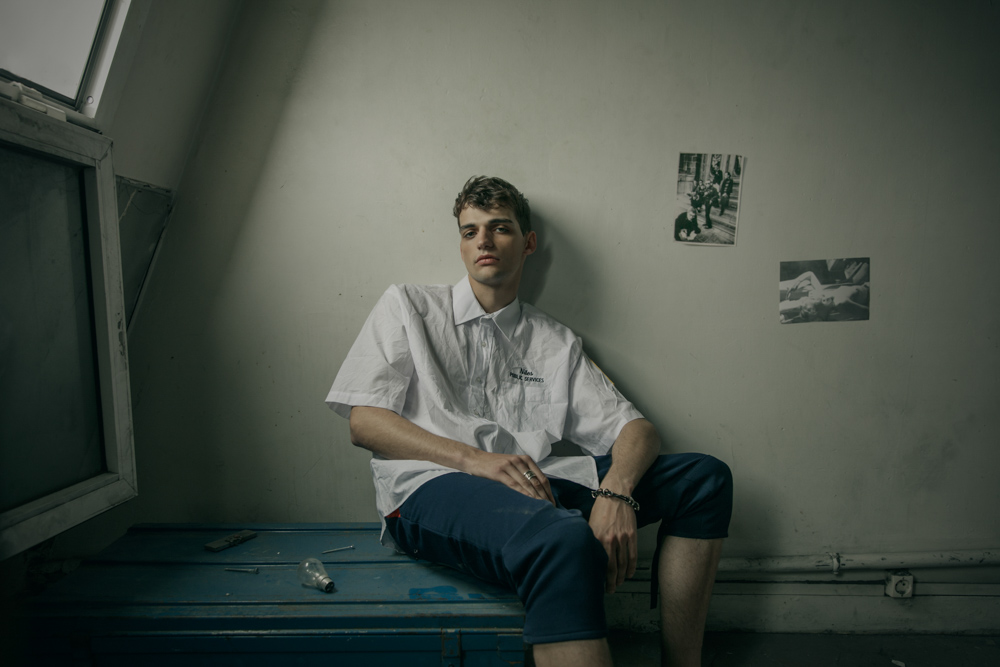 White military shirt - stylist’s own Navy blue military pants - stylist’s own Silver plated metal, leather men’s bracelet from Tribal collection by Delphine-Charlotte Parmentier Ring by Harpo