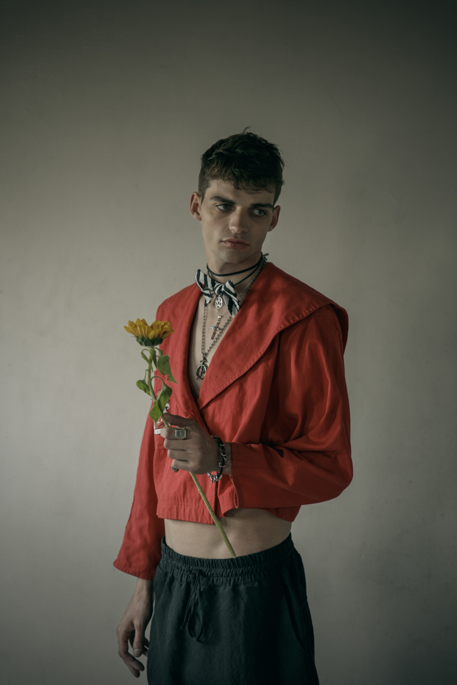 Red vintage cotton jacket - Stylist’s own Black loose trousers by Sandrine Philippe Sailor wheel necklace, cross necklace by Harpo Bowtie by Bowsdontcry Silver plated metal, leather men bracelet from Tribal collection by Delphine-Charlotte Parmentier
