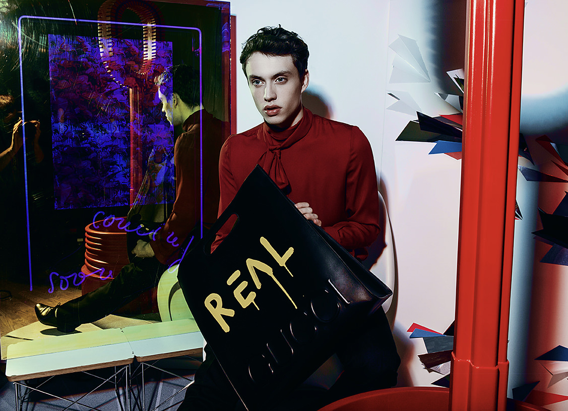 Gerry : Shirt by Gucci, Bag by Gucci, Shorts by Saint Laurent, Shoes by Saint Laurent