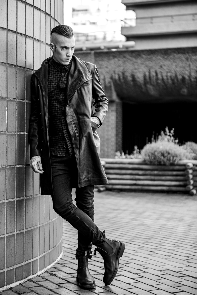 Black long leather coat DOMINGO RODRIGUEZ Black/red pattern shirt RELIGION Black trousers RELIGION Leather Chelsea boots BLUNDSTONE